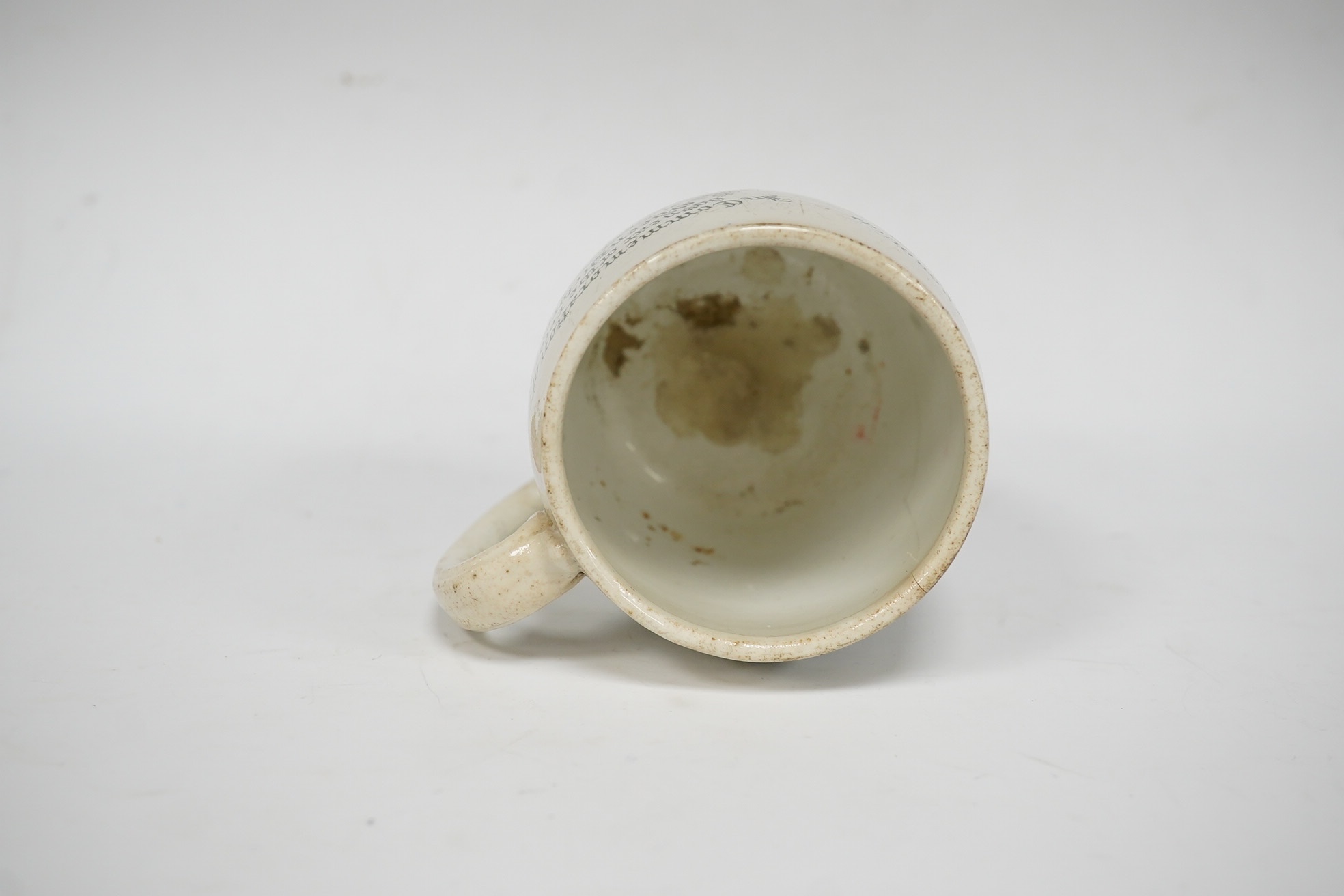 A Queen Victoria commemorative mug celebrating the 1897 Diamond Jubilee, County Borough of Brighton, 10cm high. Condition - poor